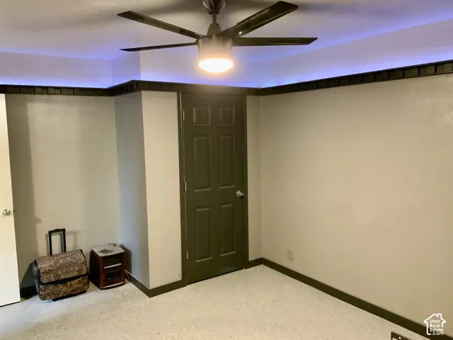 Recessed ceiling lighting, ceiling fan with integrated lighting, paneled door, and trim detailing