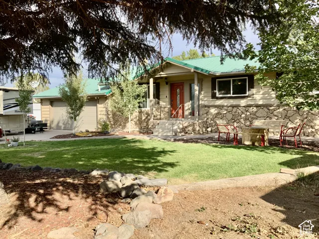 Two-car garage, stone fa