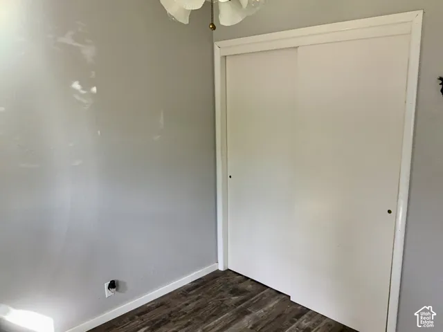 Sliding closet doors, wood-finish flooring, and a ceiling-mounted light fixture