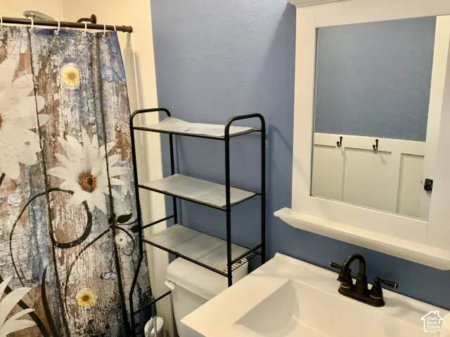 White vanity with an integrated sink and bronze-finish faucet