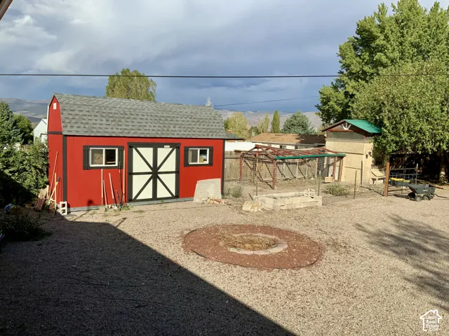 Red barn-style shed with white trim and windows