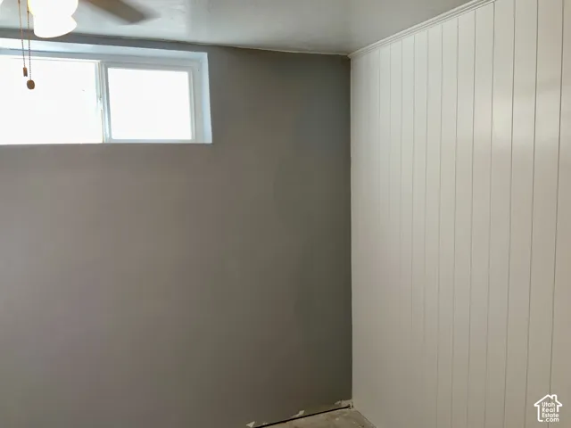 White paneled wall accenting a neutral painted wall with a double window