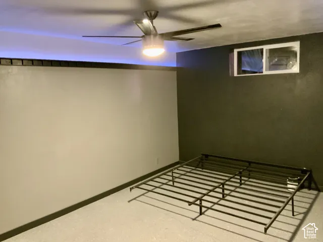 Recessed window with white trim, ceiling fan with integrated lighting, and textured wall finishes