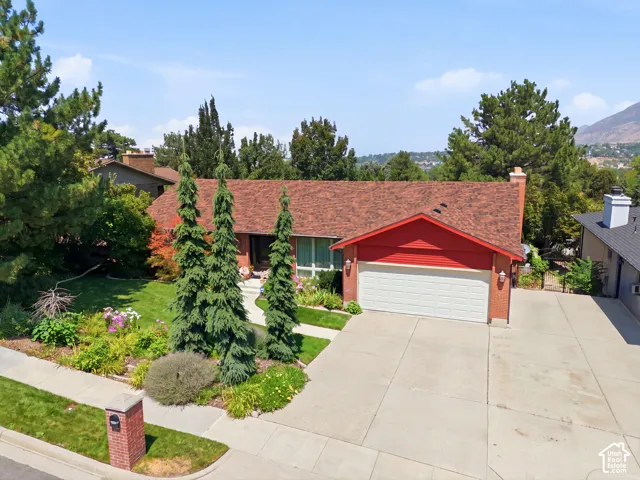 Brick-clad exterior with red siding and a prominent attached garage