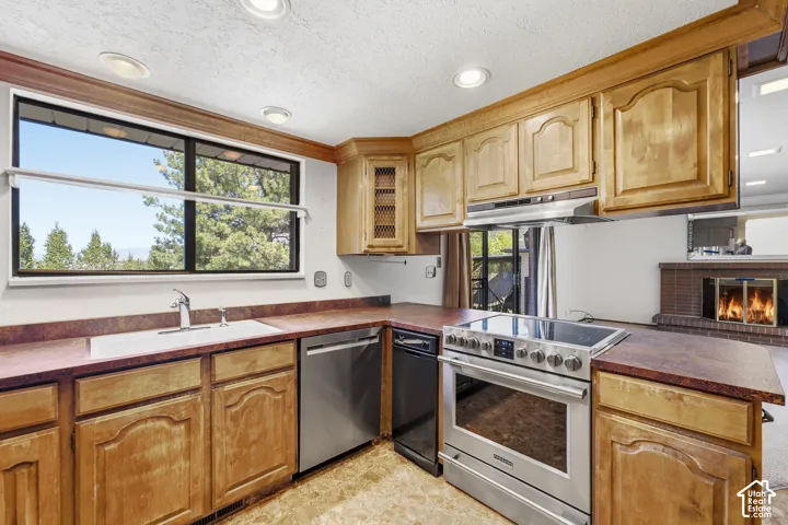 Wood-finish cabinetry and countertops with a built-in stainless steel range