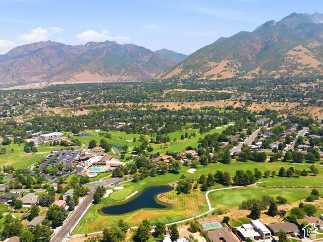 Expansive golf course setting featuring water hazards and mature landscaping