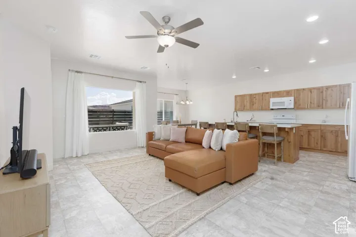 Open-concept living area with tile flooring and recessed lighting