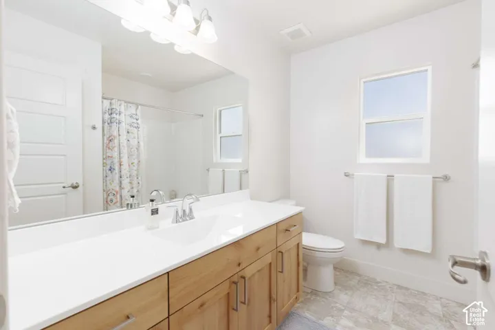 Double vanity with a white countertop and wood-finish cabinetry