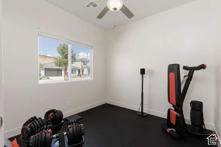 Recessed lighting, ceiling fan, large window, and dark flooring