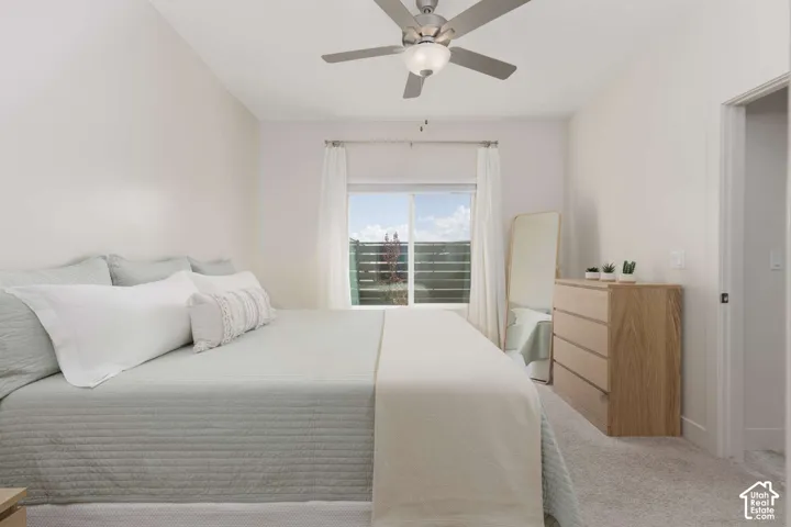 Recessed lighting, ceiling fan with integrated light, light-toned carpeting, and a window with sheer curtains