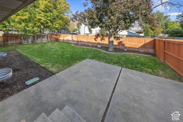 Patio area with concrete stairs and a segmented concrete slab