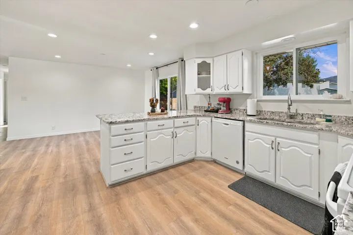 Kitchen featuring white cabinetry, light-toned wood-finish flooring, recessed lighting, and stone countertops