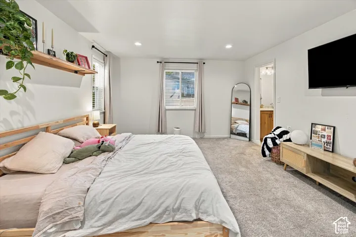 Recessed lighting, wood-finish shelving, and light gray carpeting