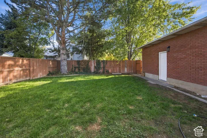 Expansive grassy yard with a wood fence perimeter