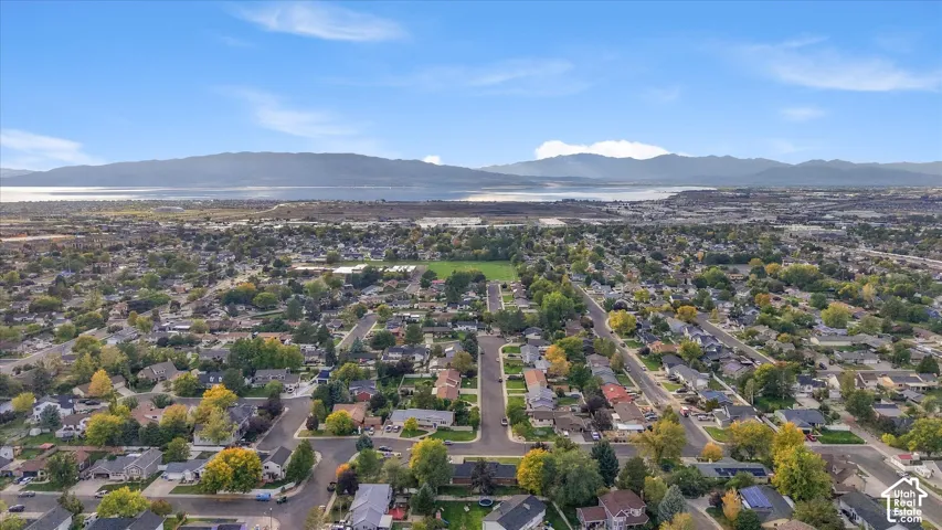 Expansive residential area with a prominent mountain range and body of water in the background