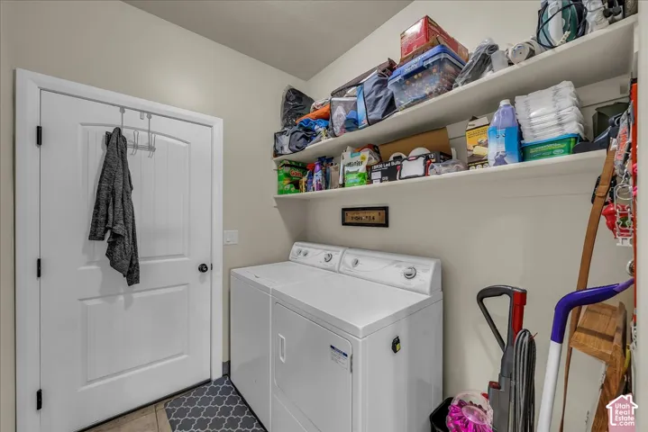 Laundry area featuring integrated shelving