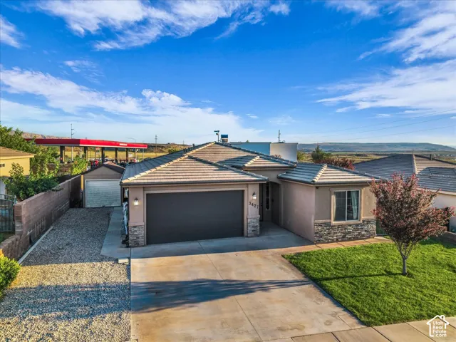 Stucco exterior with stone accents and a concrete tile roof