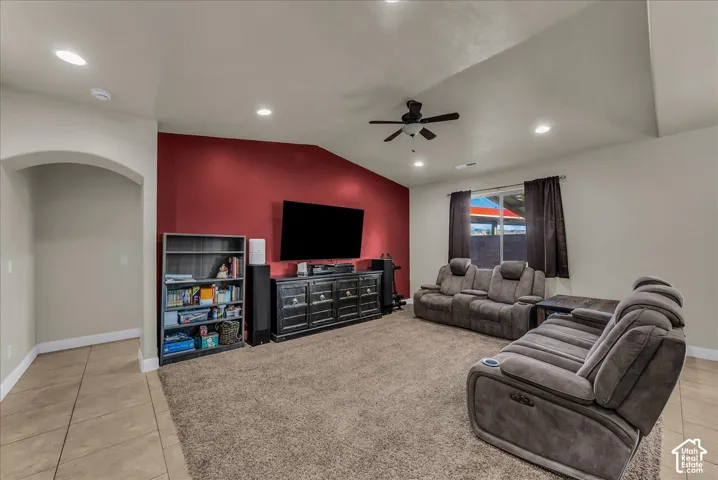 Vaulted ceiling with recessed lighting and a ceiling fan