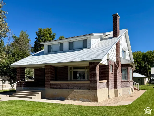 Brick exterior with white siding accents and a white roof