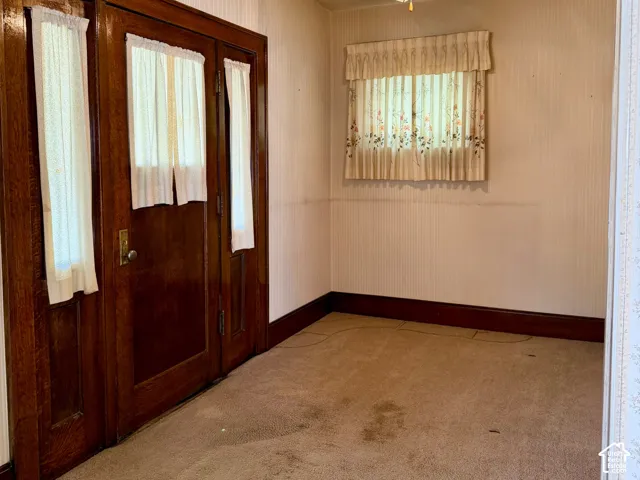 Arched doorway entry with decorative wallpaper