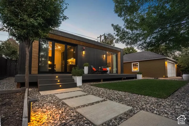 Modern exterior with dark vertical siding and wood-finish accents