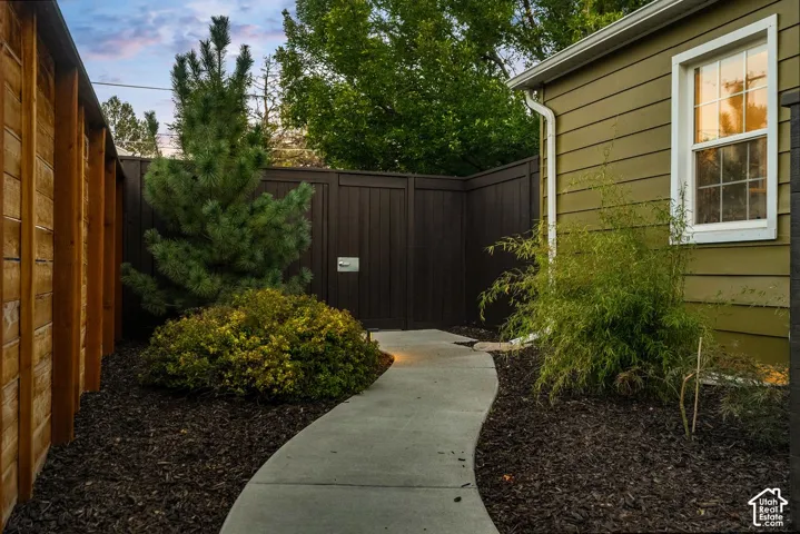 Curved concrete pathway leading to a secure gate
