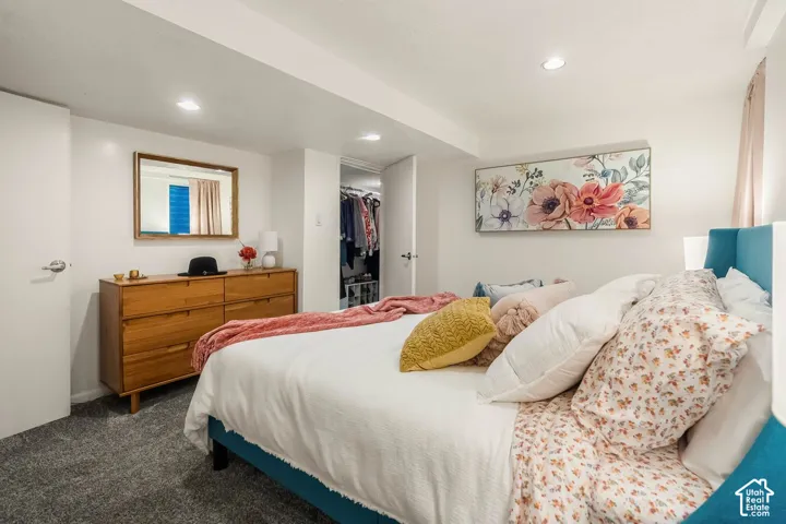 Recessed lighting, wood-finish dresser, built-in closet with organizational shelving, and carpeted flooring