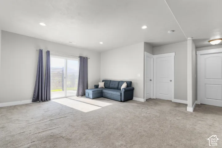 Recessed lighting, light gray carpet, and white trim throughout