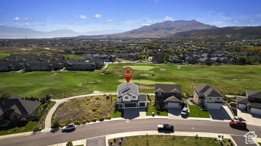 Two-story residence with a two-car garage, positioned alongside a golf course, featuring mountain and distant water scenery