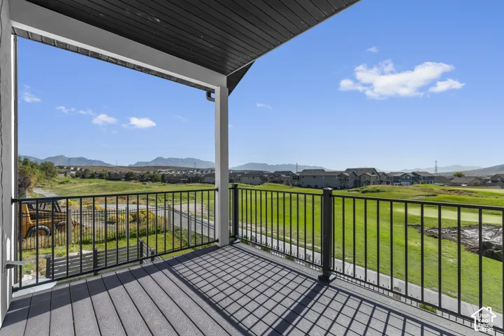 Covered balcony with composite decking and black metal railings