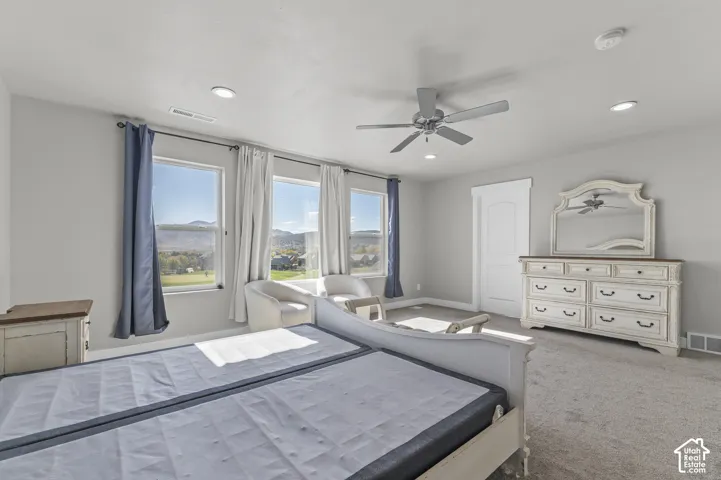Recessed lighting, ceiling fan, and carpeted flooring