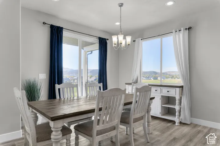 Recessed lighting, wood-finish flooring, and a sliding glass door