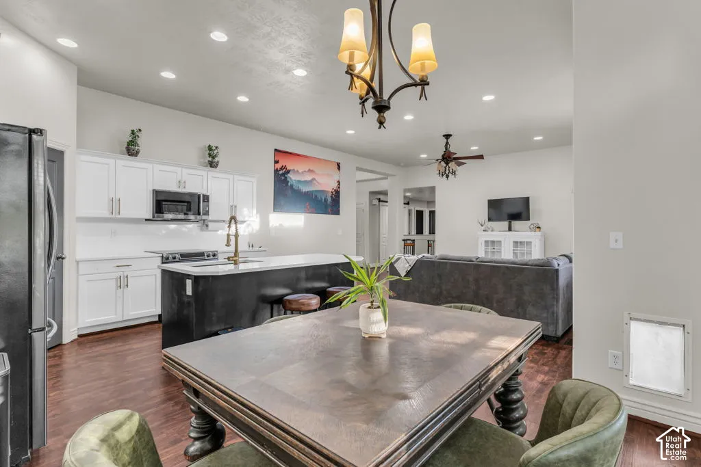 Open concept living space featuring wood-finish flooring, recessed lighting, and a chandelier