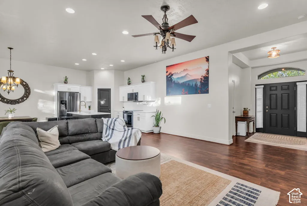 Wood-finish flooring, recessed lighting, and a ceiling fan with light fixture