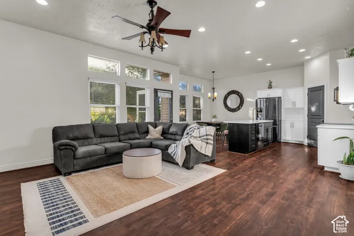 Spacious living area with wood-finish flooring, recessed lighting, and a ceiling fan