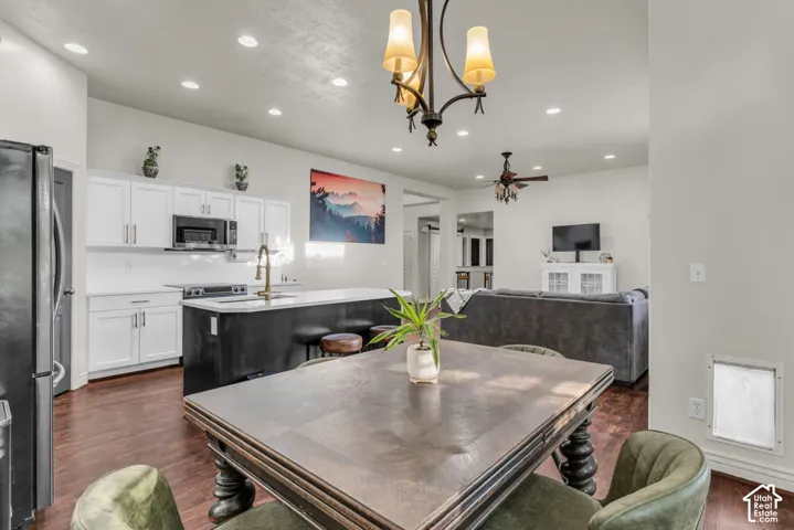 Open concept living space featuring wood-finish flooring, recessed lighting, and a chandelier