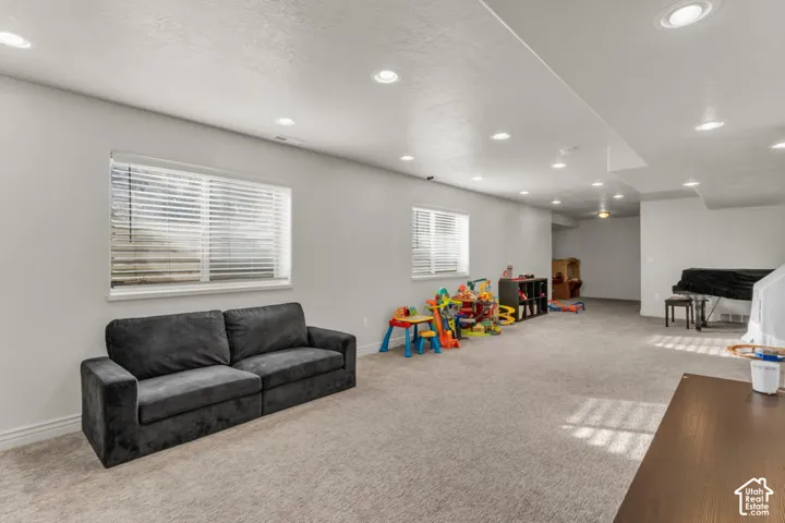 Expansive carpeted room featuring recessed lighting, multiple windows, and light-toned walls