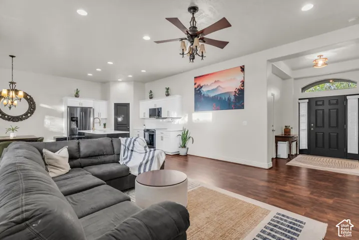 Wood-finish flooring, recessed lighting, and a ceiling fan with light fixture