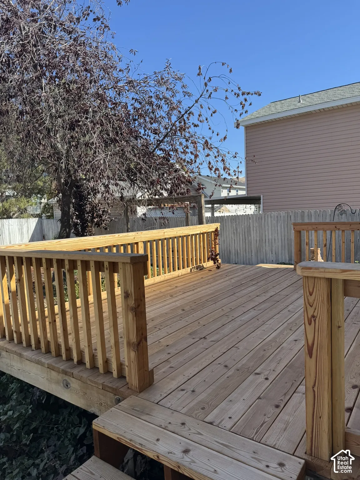 Expansive wood deck with railing and visible steps