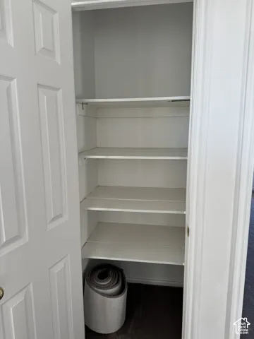 Recessed closet with multiple white shelving units