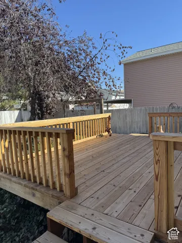 Expansive wood deck with railing and visible steps