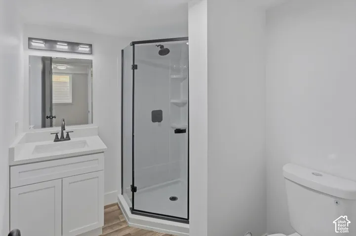 White vanity with a solid surface countertop, undermount sink, and matte black faucet