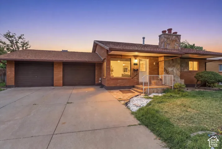 Brick ranch home with dual-car garage and extended driveway