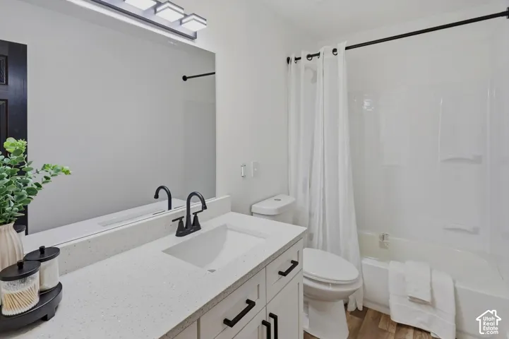 Contemporary bathroom featuring a dual-sink vanity with quartz countertop, matte black hardware, and ample storage