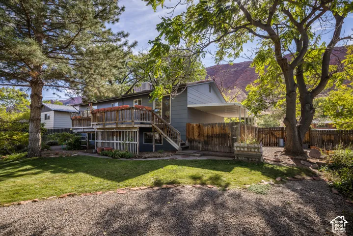 Two-story exterior with multi-level wood decking and stairs