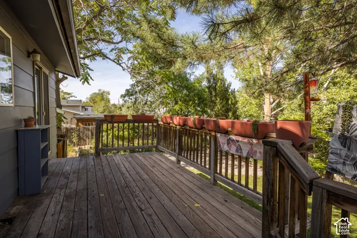 Wood deck with a wood railing and a sliding glass door