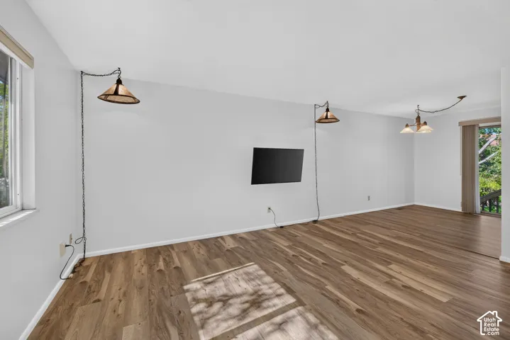 Wood-finish flooring, white walls, and a glass sliding door
