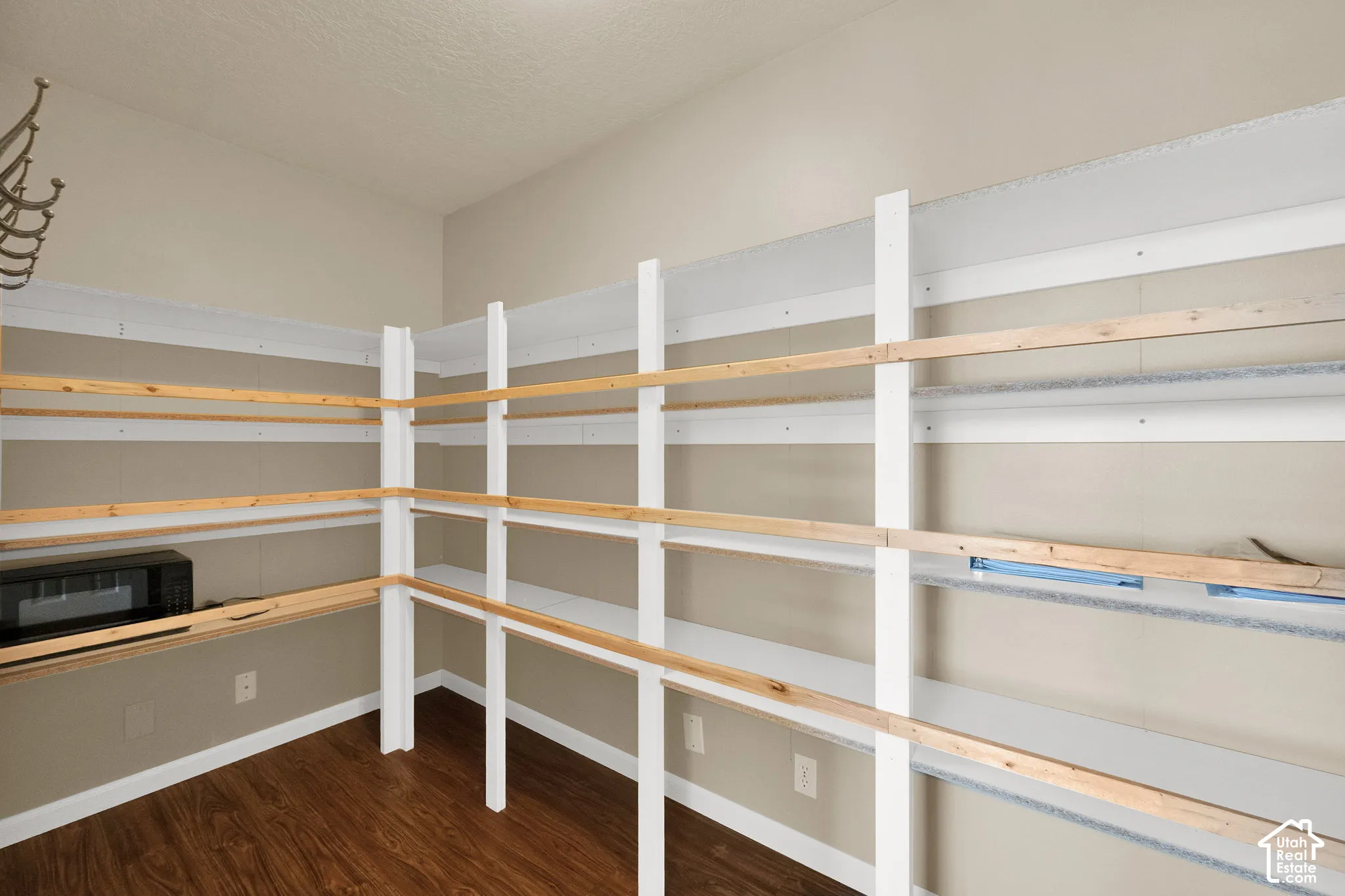 Comprehensive pantry shelving system with wood-finish flooring