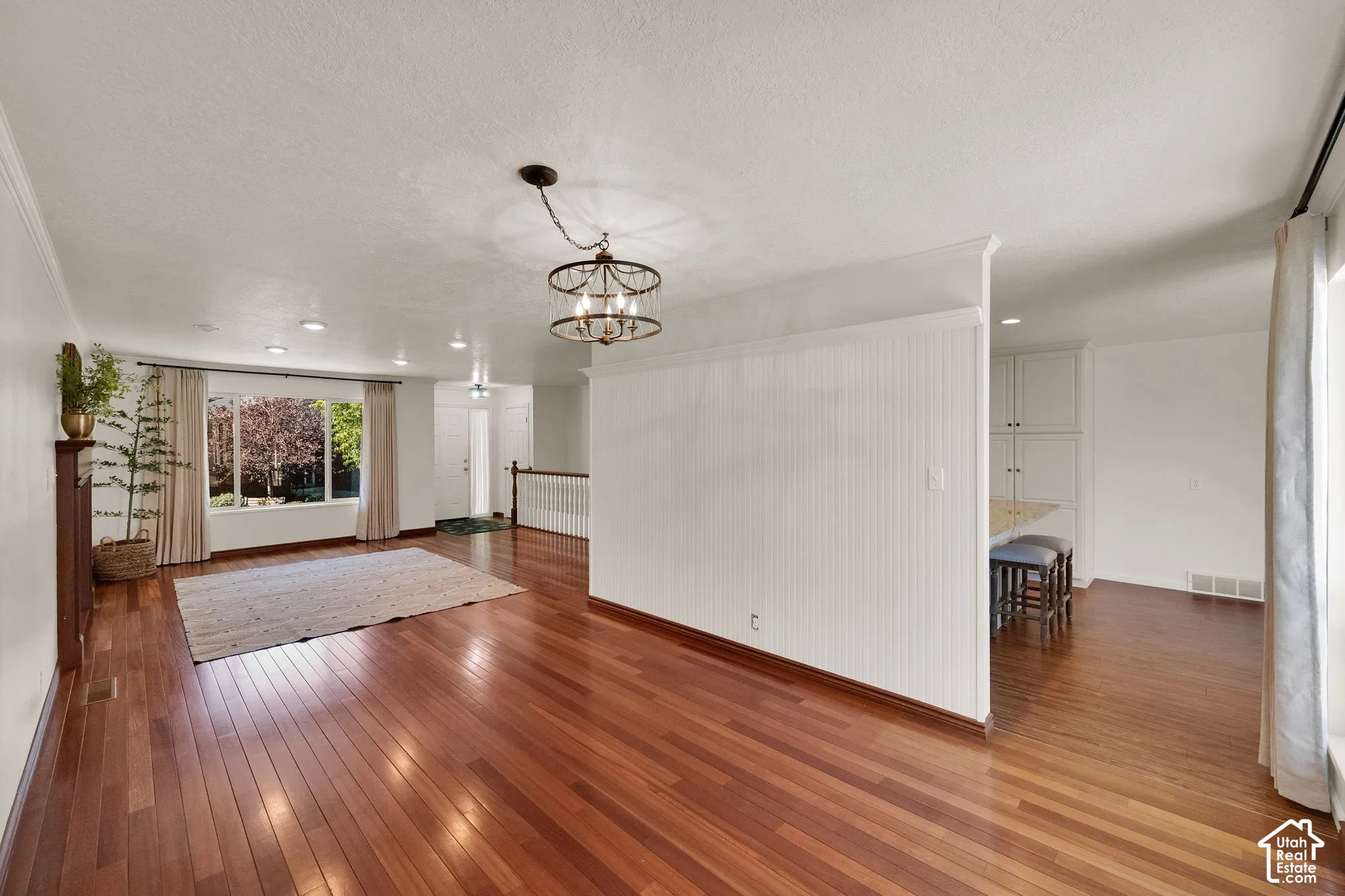 Hardwood flooring, recessed lighting, and chandelier