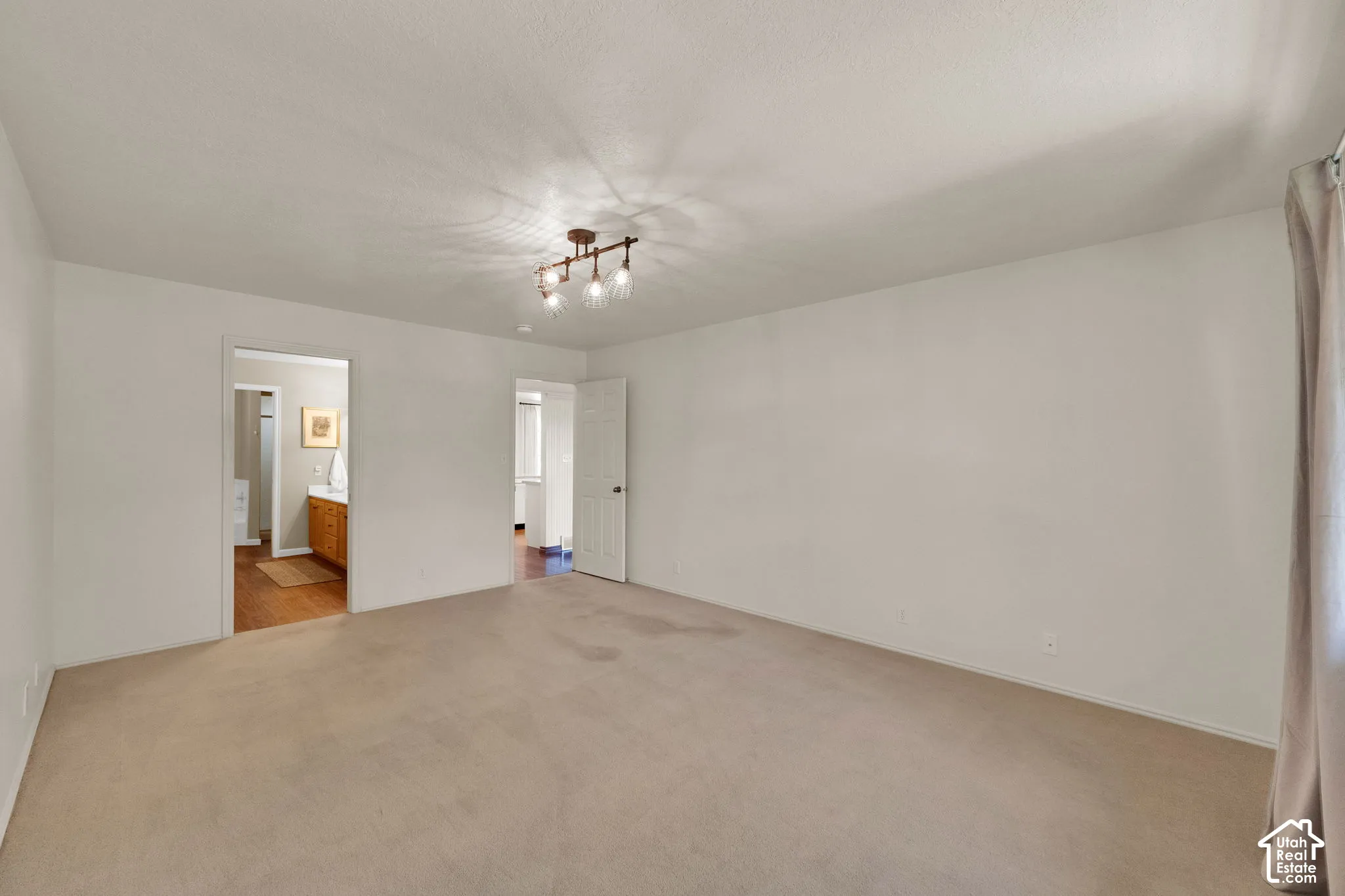 Spacious room, light-colored carpet, with connected bathroom